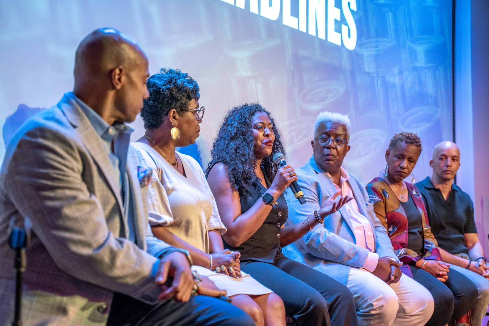 A journalist telling her story on stage at Behind the Headlines